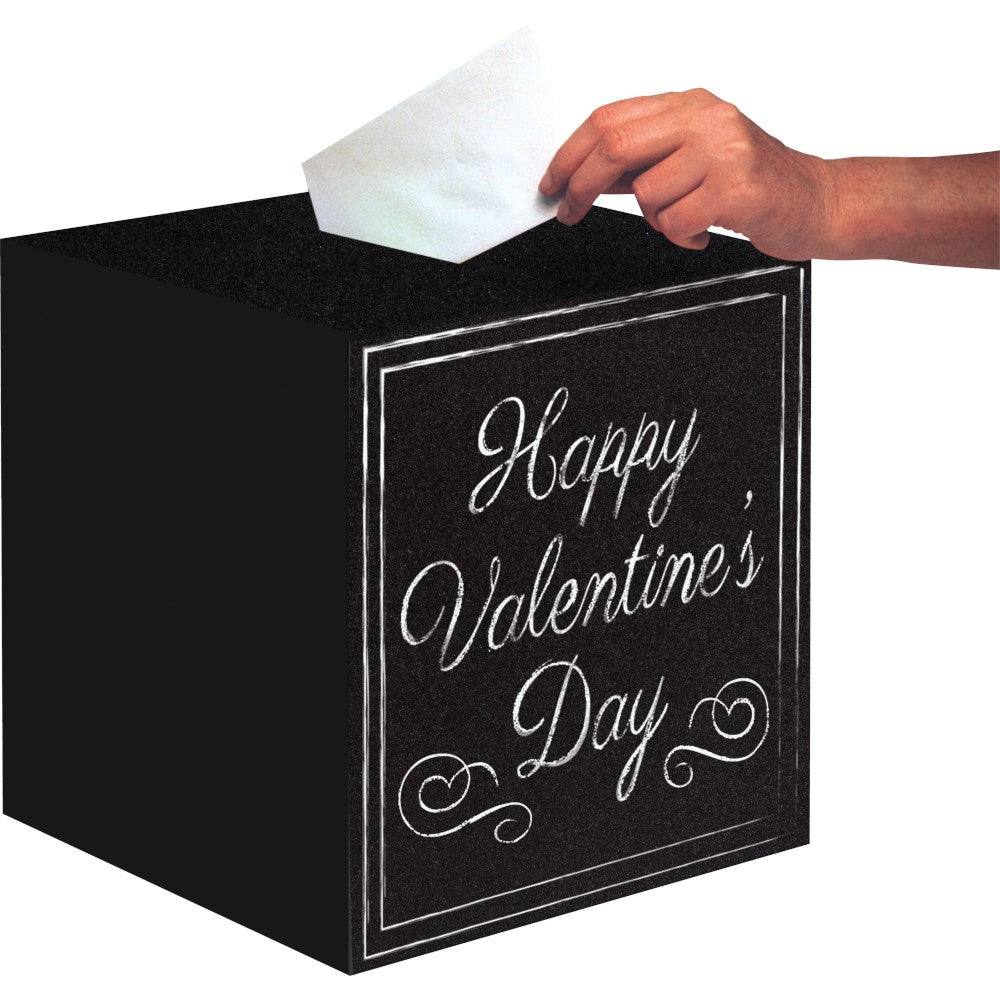 Black chalkboard card box with white decorative script reading "Happy Valentine's Day" and a hand inserting a white envelope.
