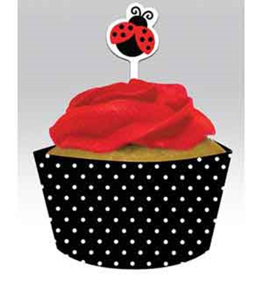 Black cupcake wrapper with white polka dots topped with red frosting and a red ladybug pick decoration.
