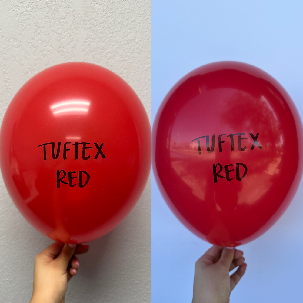 Two shiny red latex balloons, each 11 inches, with "Tuftex Red" printed in black on the surface.