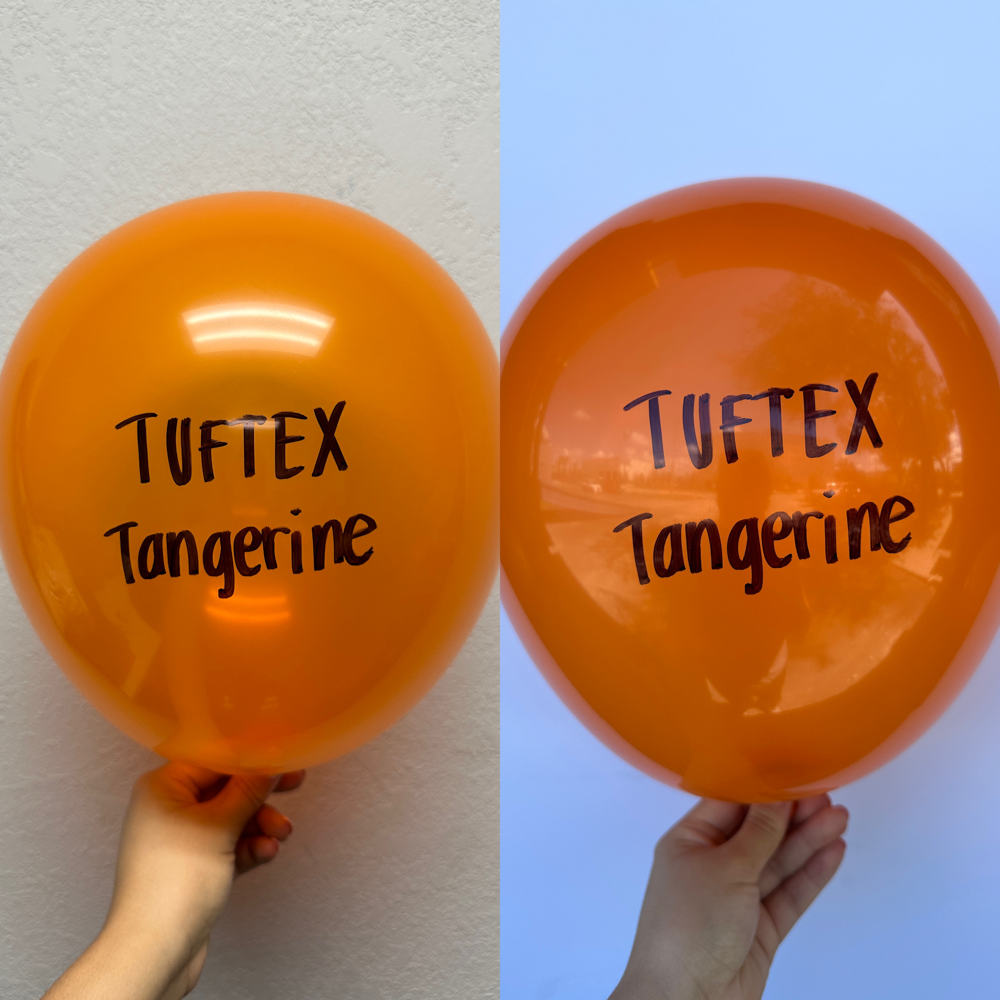 Bright orange latex balloon with Tuftex Tangerine printed in black, 11-inch round shape.