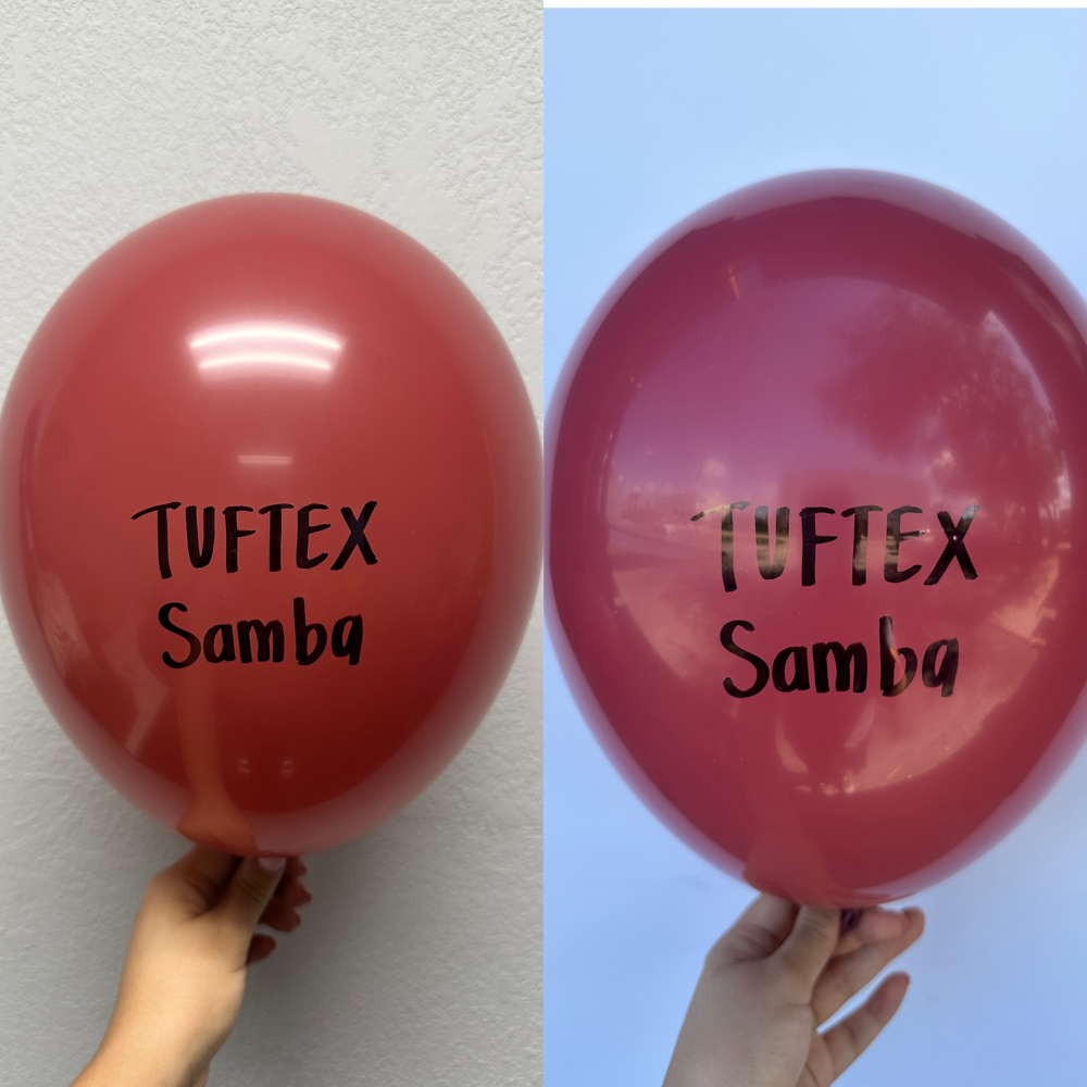 Glossy red 11-inch latex balloon with black "Tuftex Samba" text, held by hand against plain backgrounds.