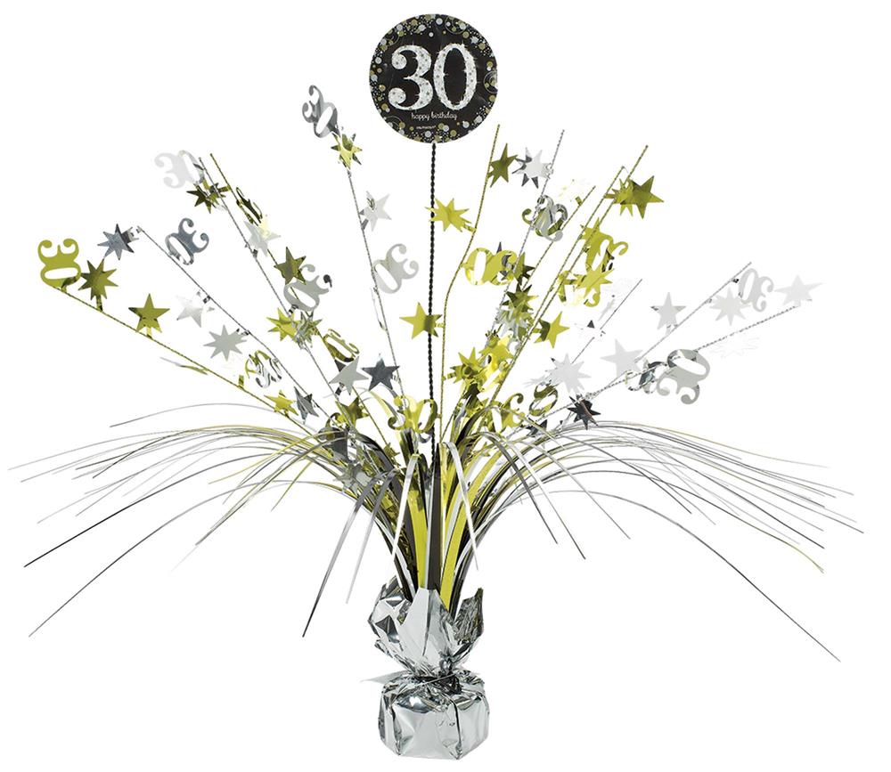 Gold and silver "30" birthday spray centerpiece with stars, swirls, and metallic strands in foil-wrapped base.