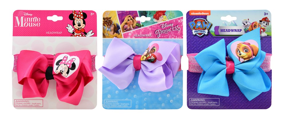 Set of four colorful elastic headwraps with bows featuring Minnie Mouse, Disney Princess, and Paw Patrol designs on display.