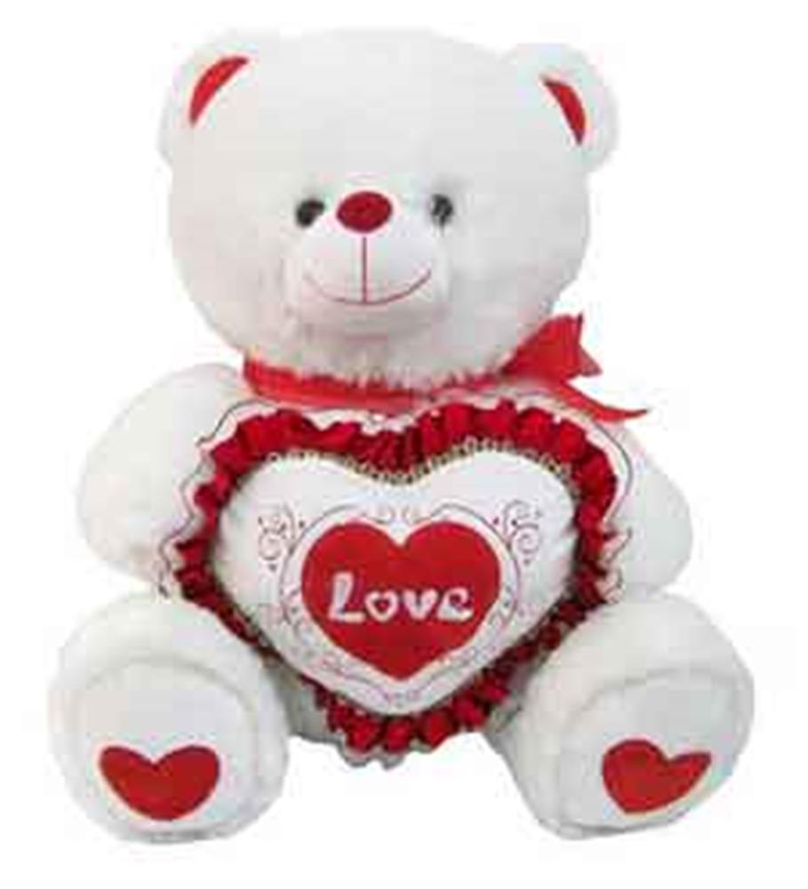 White plush teddy bear holding red and white heart pillow with "Love" text and red ribbon bow.
