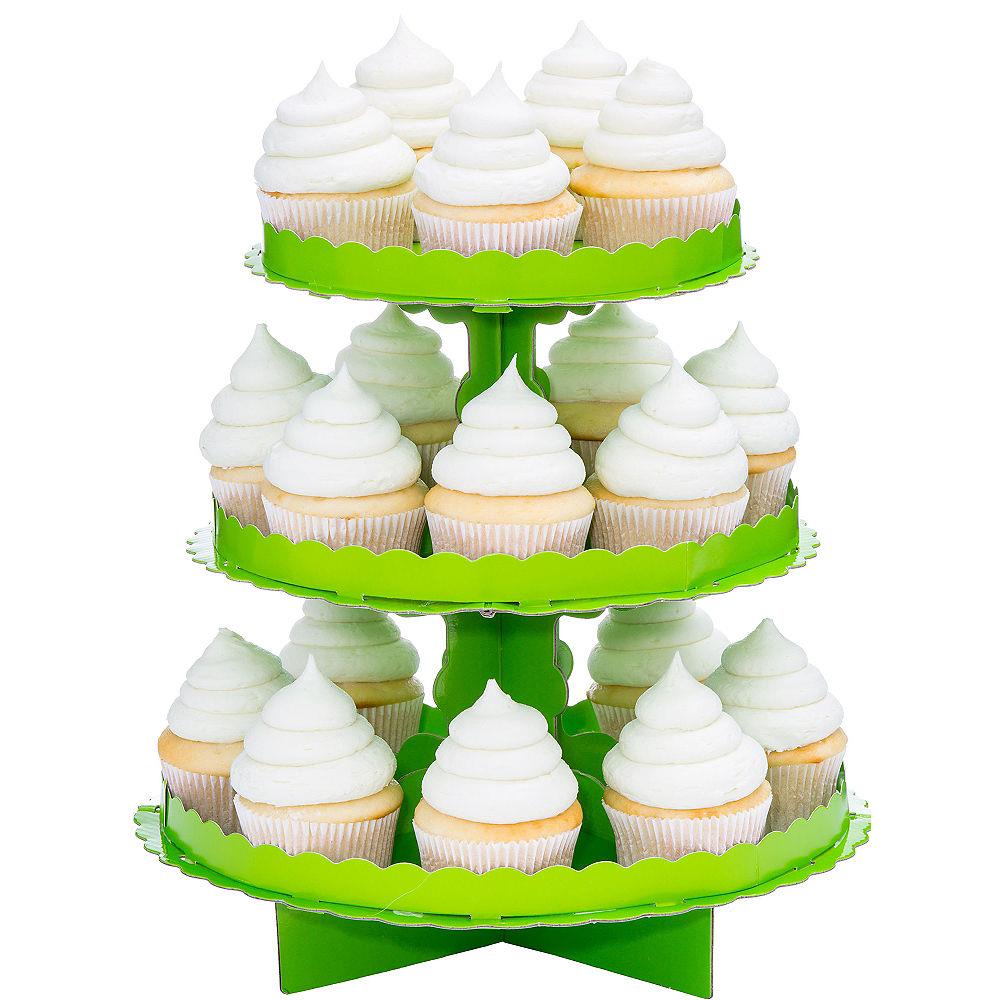 Three-tiered bright green cupcake stand holding white-iced cupcakes with golden bases.