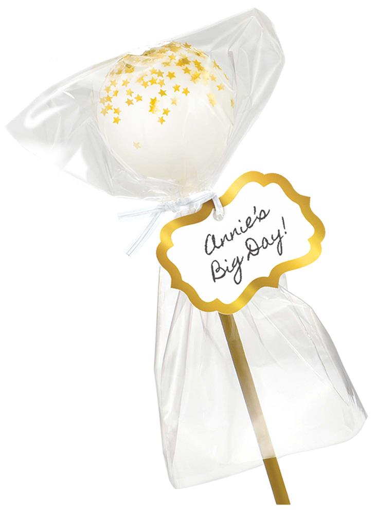 White cake pop with gold sprinkles wrapped in clear plastic with a gold-bordered tag and gold stick.