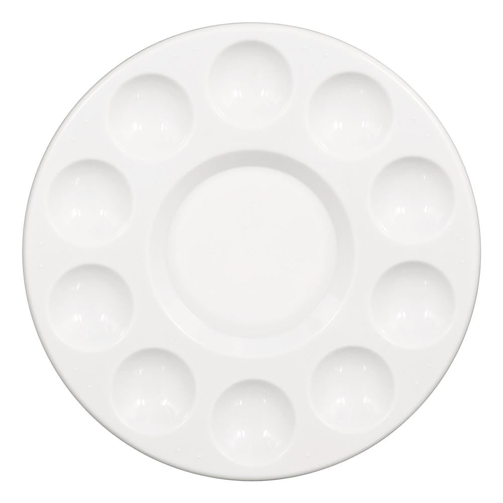 White round ceramic tray with ten small wells arranged around a larger central well, designed for baking cupcakes or serving