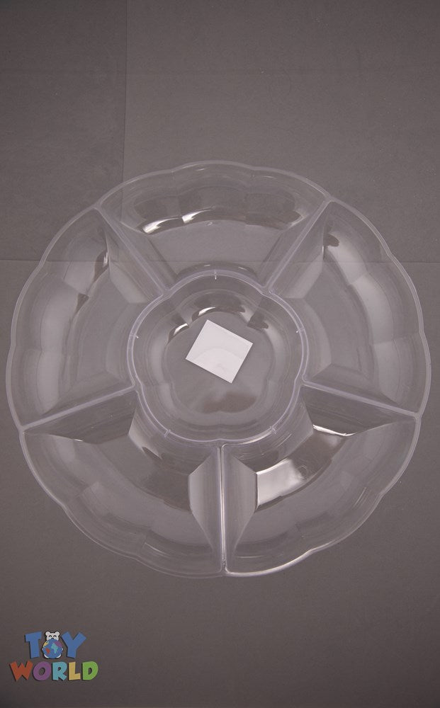 Clear round plastic serving tray with six evenly divided sections and a central dip bowl.