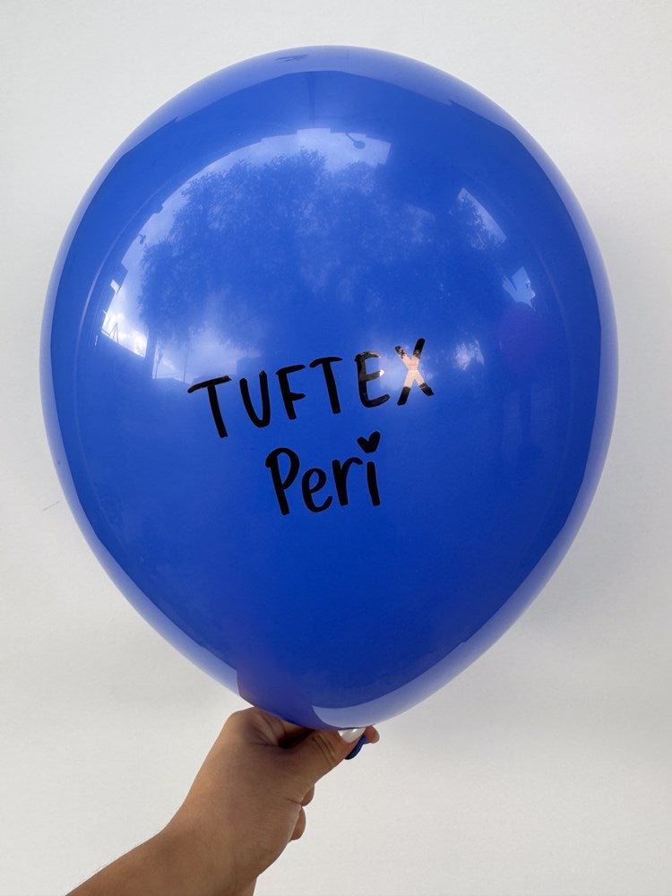 Bright blue 5-inch latex balloon with black "Tuftex Peri" text held against a white background.