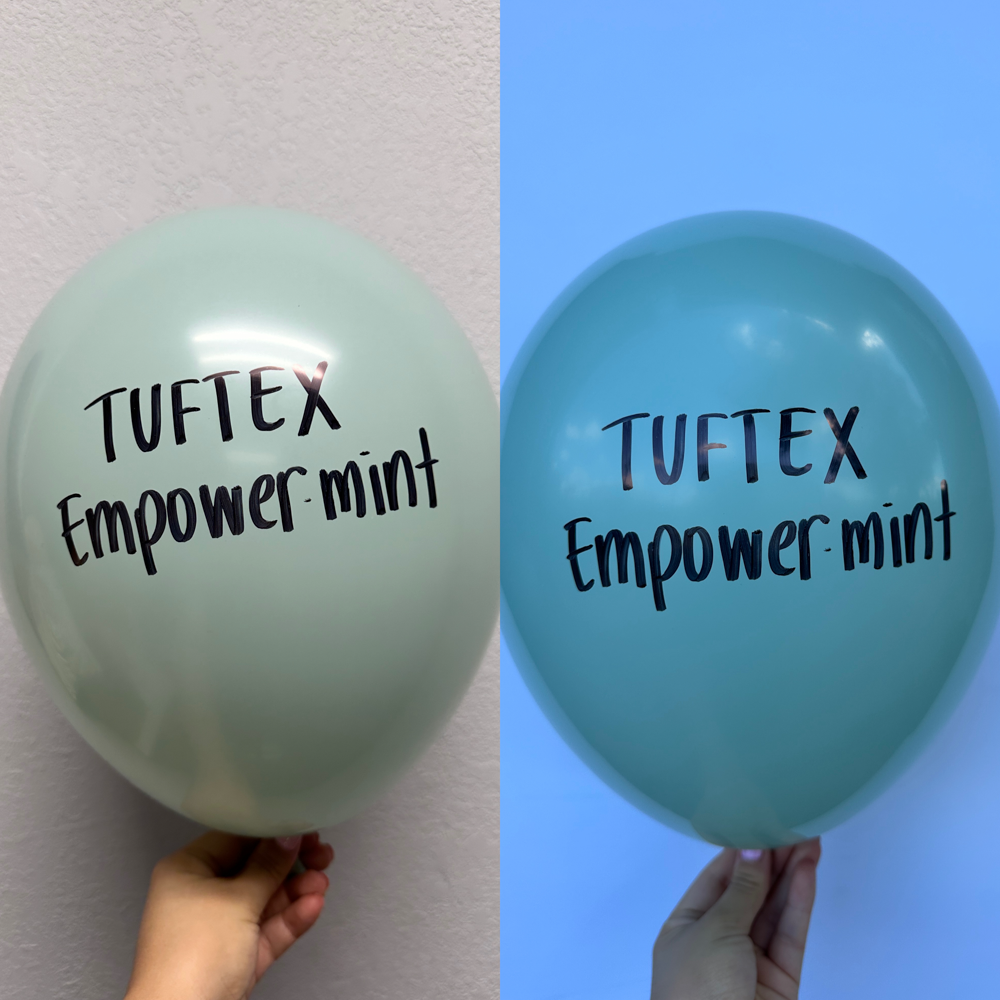Two 5-inch latex balloons in shades of mint green with "Tuftex Empower-mint" text printed in black, held against neutral and