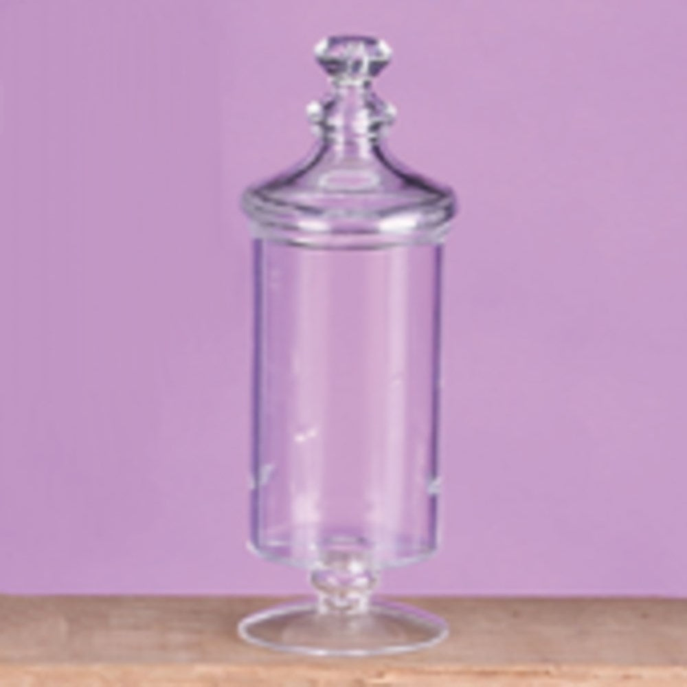 Tall clear glass candy container with lid and pedestal base, classic apothecary style.