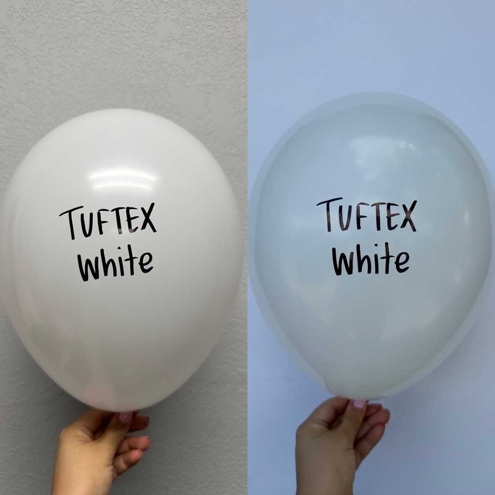 Glossy white latex balloon inflated to 17 inches with black "Tuftex white" text, held by hand.