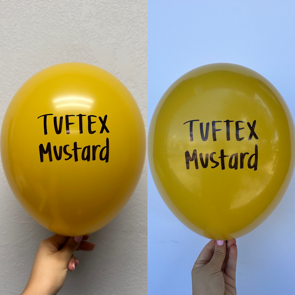 Hand holding a shiny mustard yellow 17-inch latex balloon with black "Tuftex Mustard" text, front and back views.