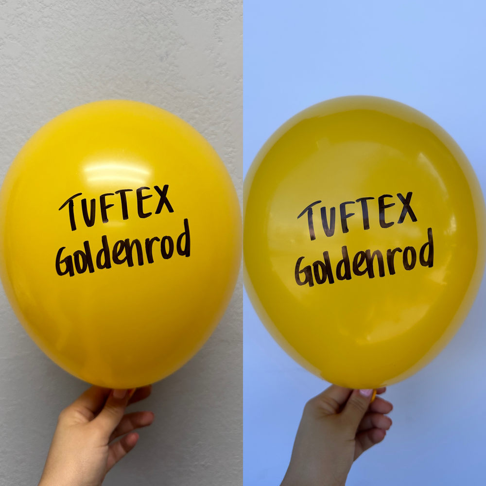 Bright goldenrod yellow latex balloon with Tuftex Goldenrod logo in black, round shape, 17 inch inflated size, held by hand.