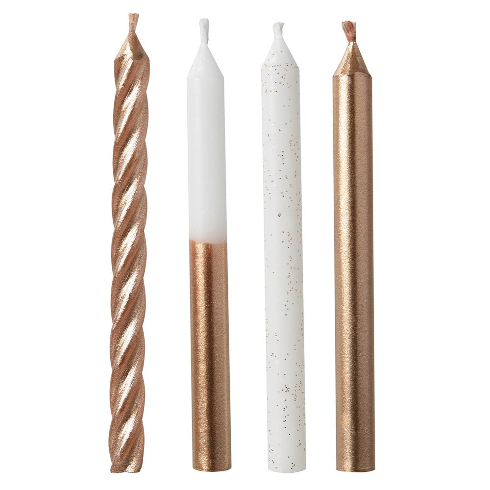 Set of four slim candles in rose gold and white, including twisted, dipped, speckled, and metallic finishes.