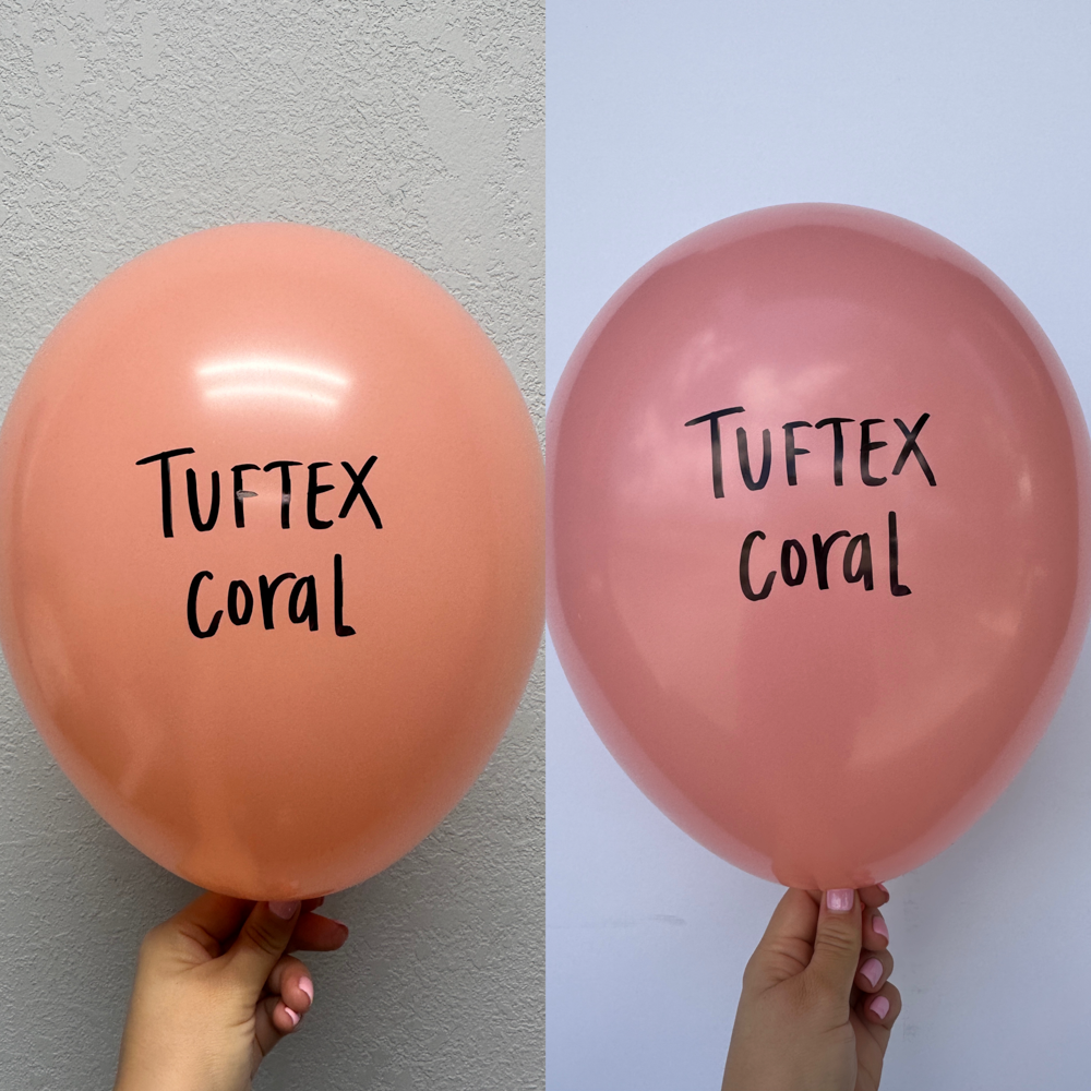 Two coral-colored 17-inch latex balloons with "Tuftex Coral" printed in black, held against a neutral wall.