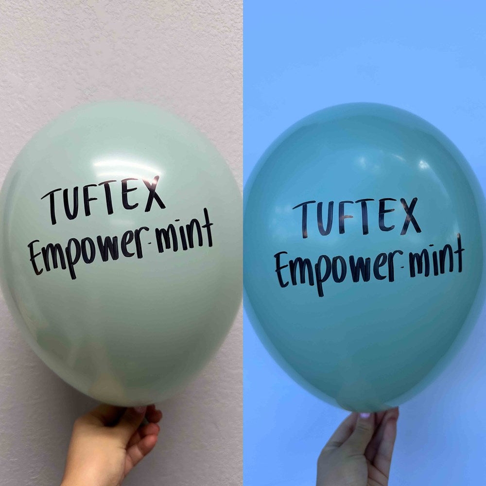 Two 17-inch round latex balloons in light and medium green shades, each printed with "Tuftex Empower mint" in black text.