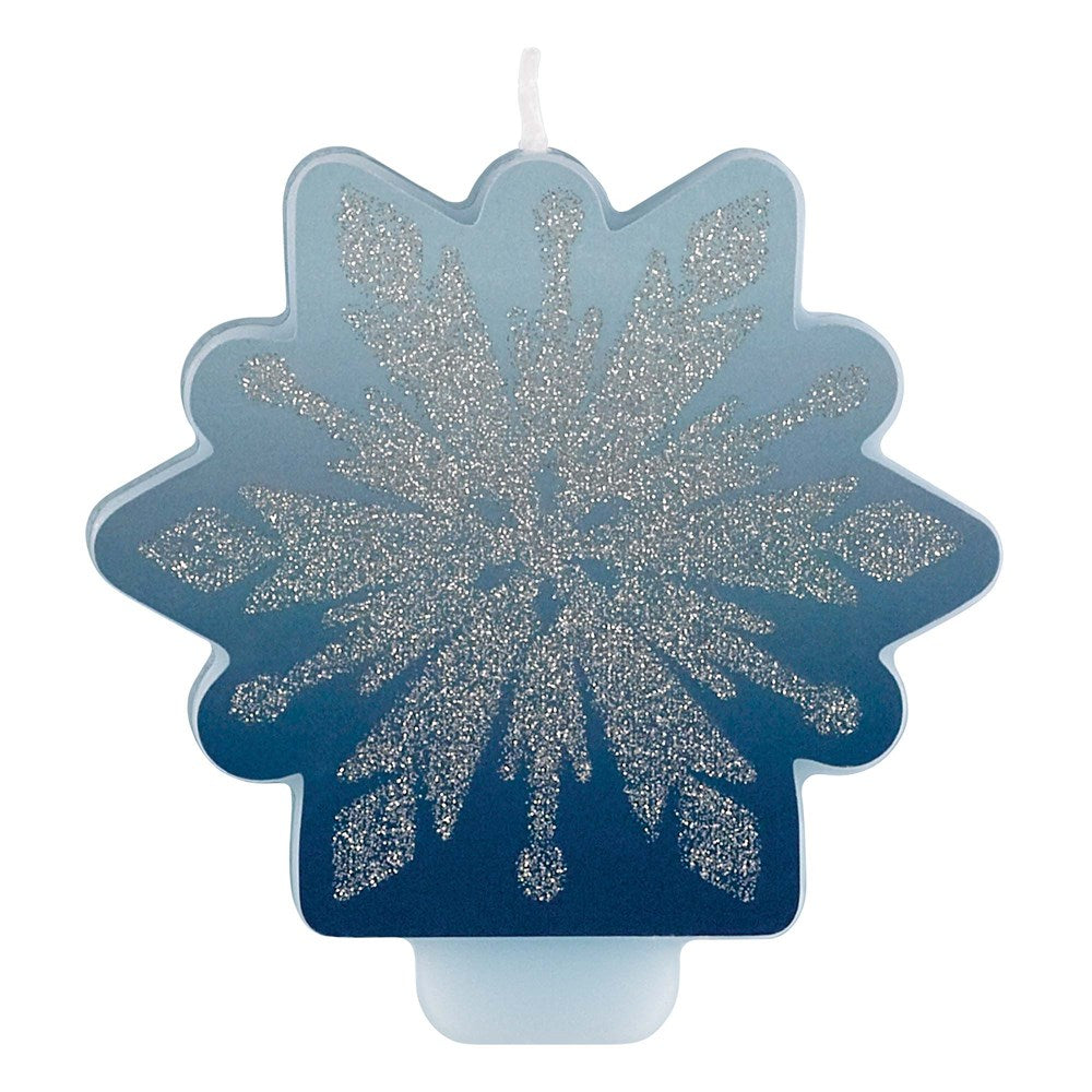 Blue snowflake-shaped candle with silver glitter details and a white base wick.