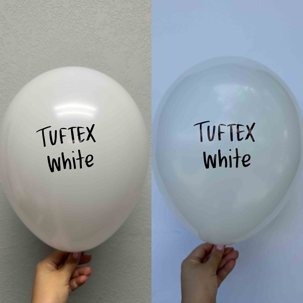 Set of two 17-inch white latex balloons with "Tuftex white" printed in black on the front, held by hand.