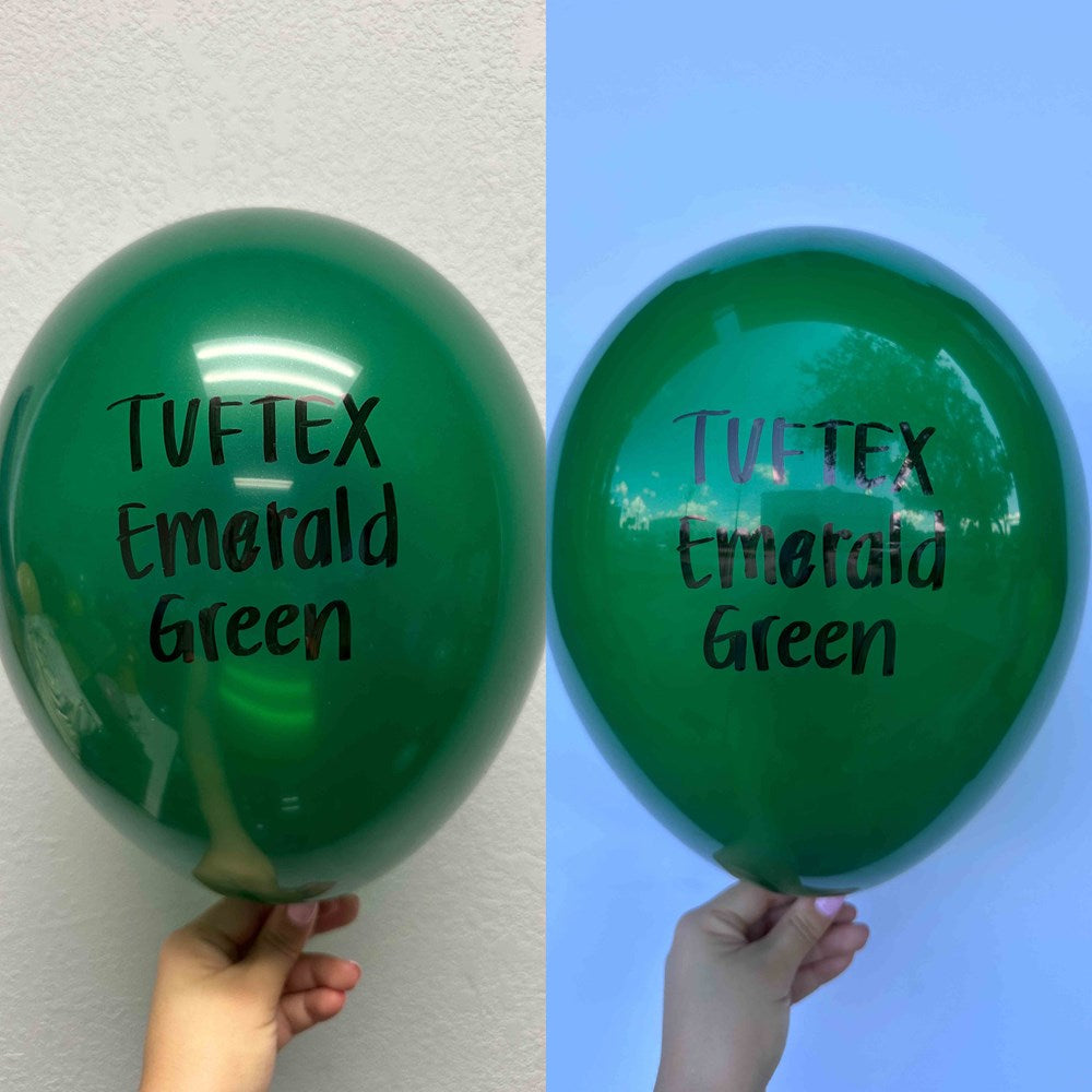 Shiny emerald green latex balloon, 17 inches, with Tuftex branding and smooth surface held by hand against neutral.