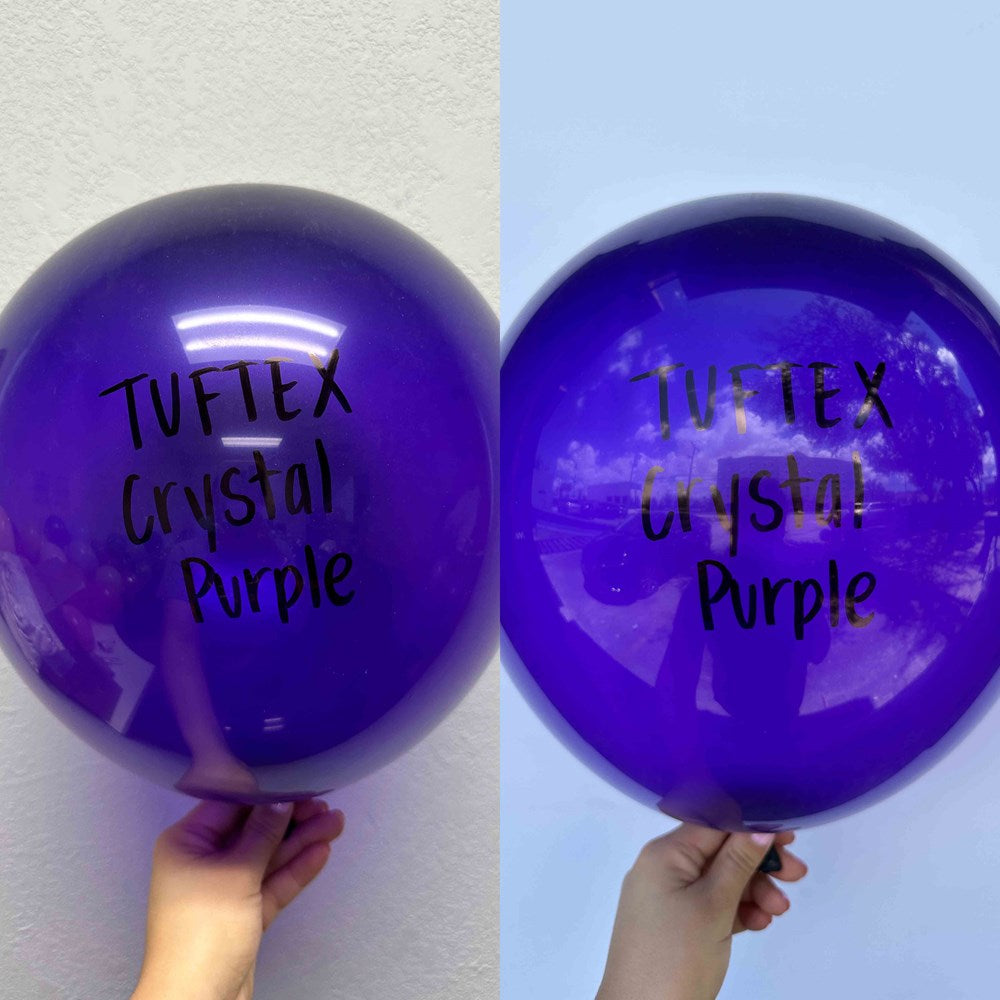 Glossy deep purple 17-inch latex balloon with black "Tuftex Crystal Purple" text, held by hand.