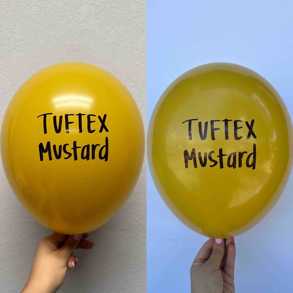 Set of two round mustard yellow latex balloons, each printed with "Tuftex Mustard" in black font, 17 inches inflated size,.