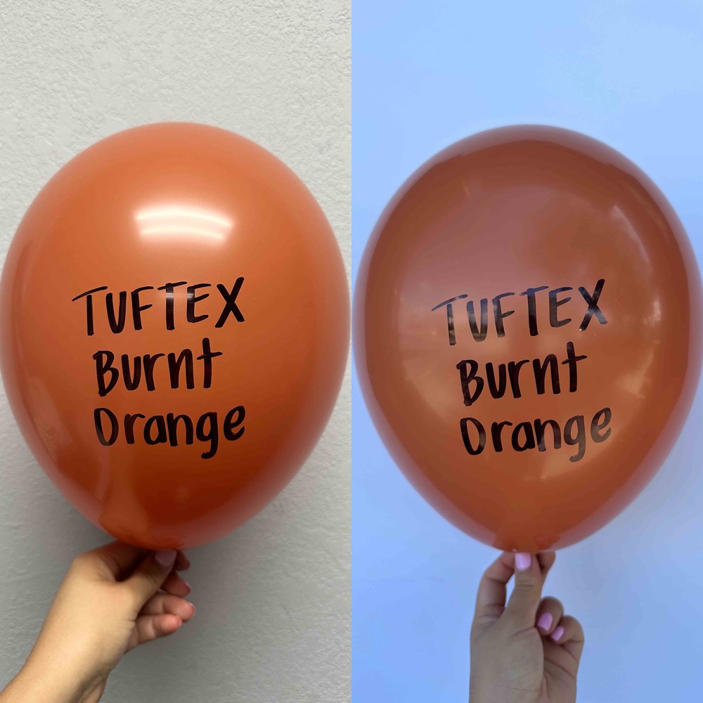 Two burnt orange 17-inch latex balloons with "Tuftex Burnt Orange" printed in black text, shiny surface.