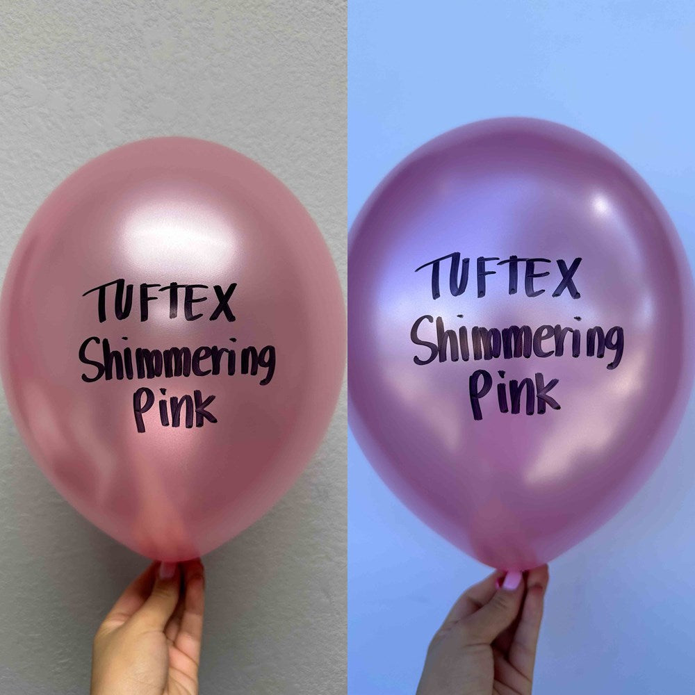 Two 17-inch pearlized pink latex balloons with a shimmering finish, each held by a hand, displaying the "Tuftex Shimmering.