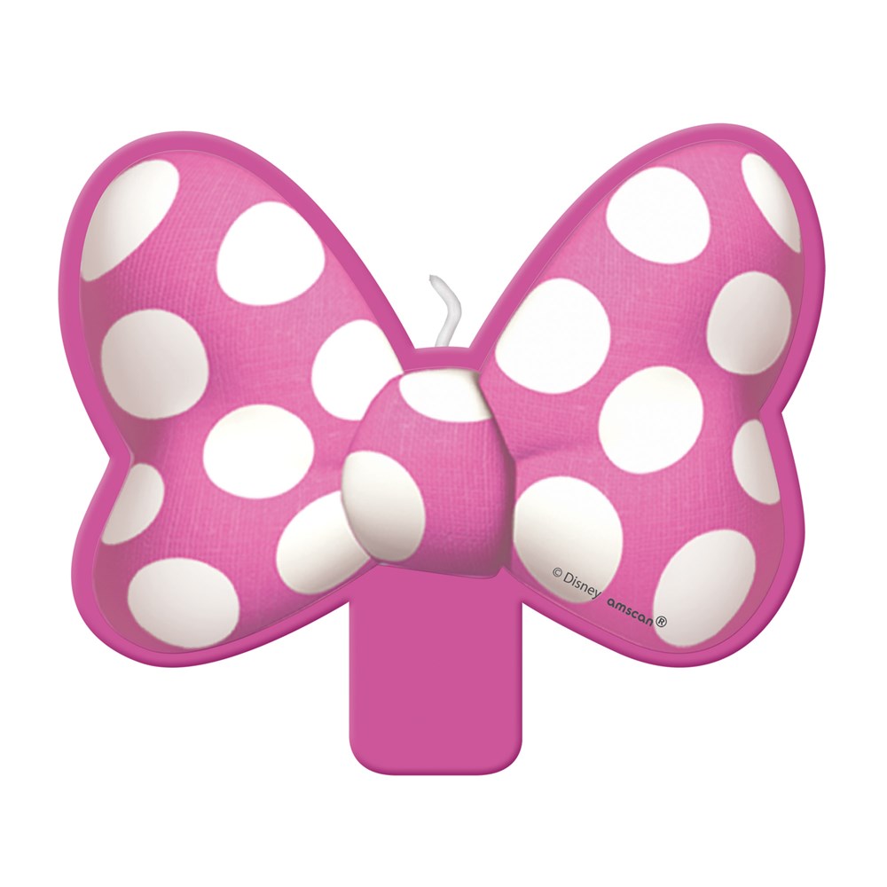 Pink polka-dot bow-shaped birthday candle with white spots and central white wick.
