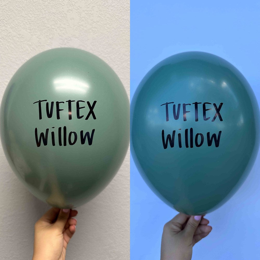 Green latex balloon with black "Tuftex Willow" text, 17-inch round shape, held by hand.