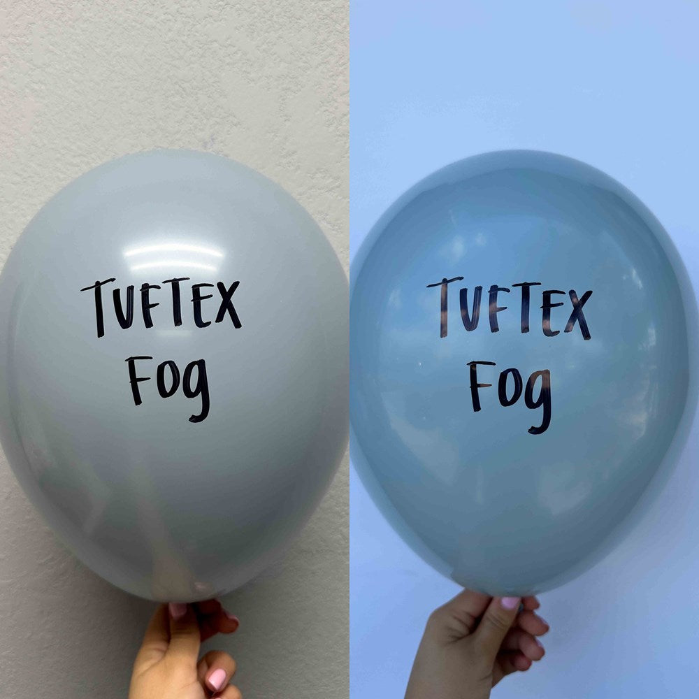 Two 17-inch fog blue latex balloons with "Tuftex Fog" printed in black on the surface, held against neutral backgrounds.