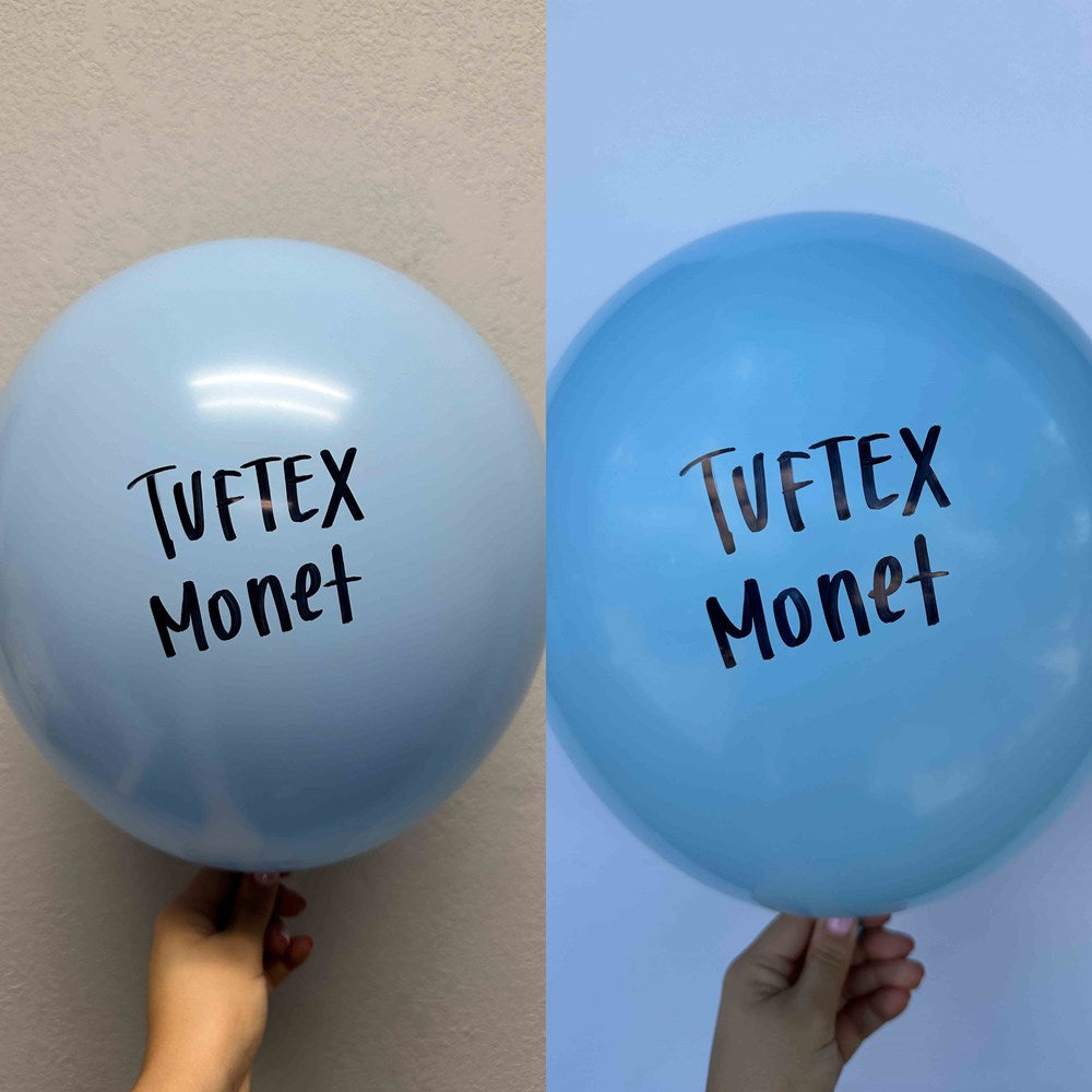 Set of two 17-inch round light blue latex balloons with "Tuftex Monet" printed in black letters.