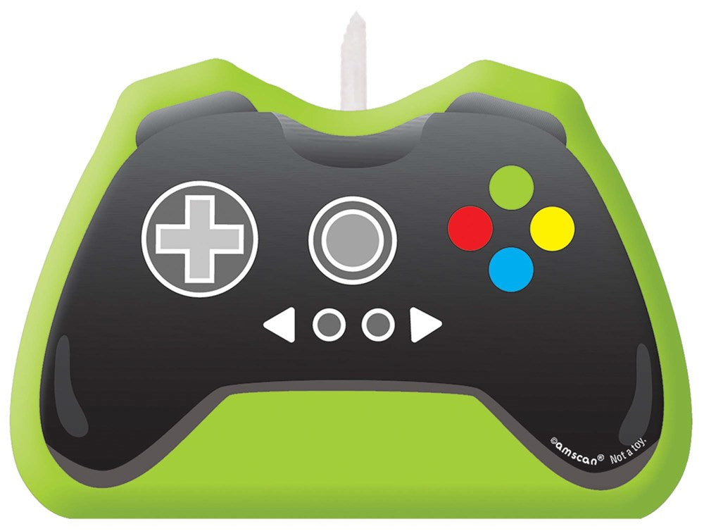 Green birthday candle shaped like a black video game controller with colorful buttons.