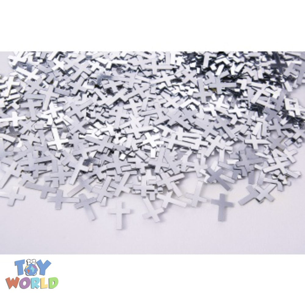 Small silver cross-shaped confetti pieces scattered on a white surface.