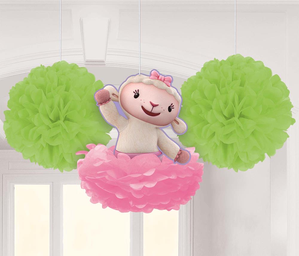 Three hanging decorations with two green tissue paper pom-poms and a pink pom-pom featuring a smiling lamb character on top.