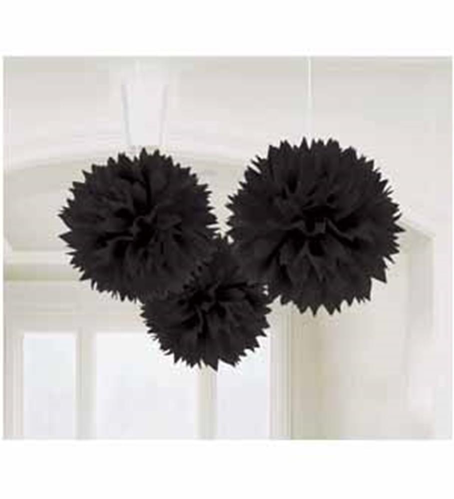 Three black tissue paper pom-pom decorations hanging from ceiling.