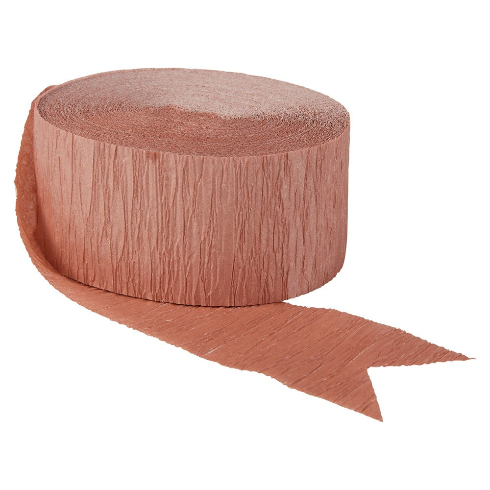 Rose gold crepe paper roll with textured surface and one end cut into a notch.