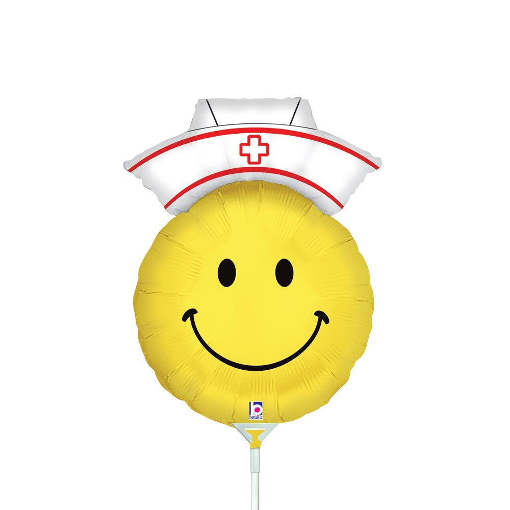 Yellow round smiley face balloon with black eyes and smile, wearing white nurse hat with red cross and trim.