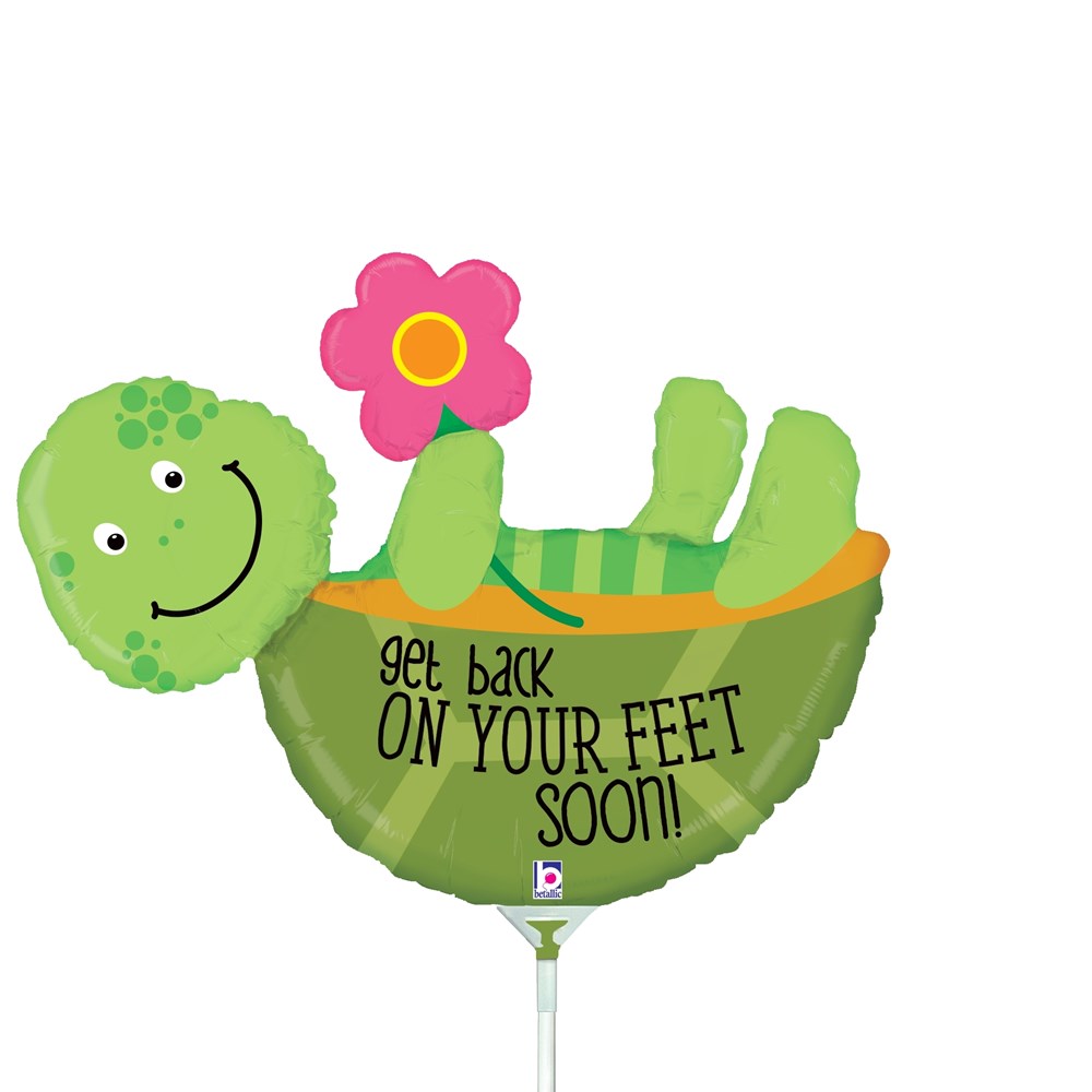 Green turtle-shaped foil balloon holding a pink flower, with "get back on your feet soon!" text.