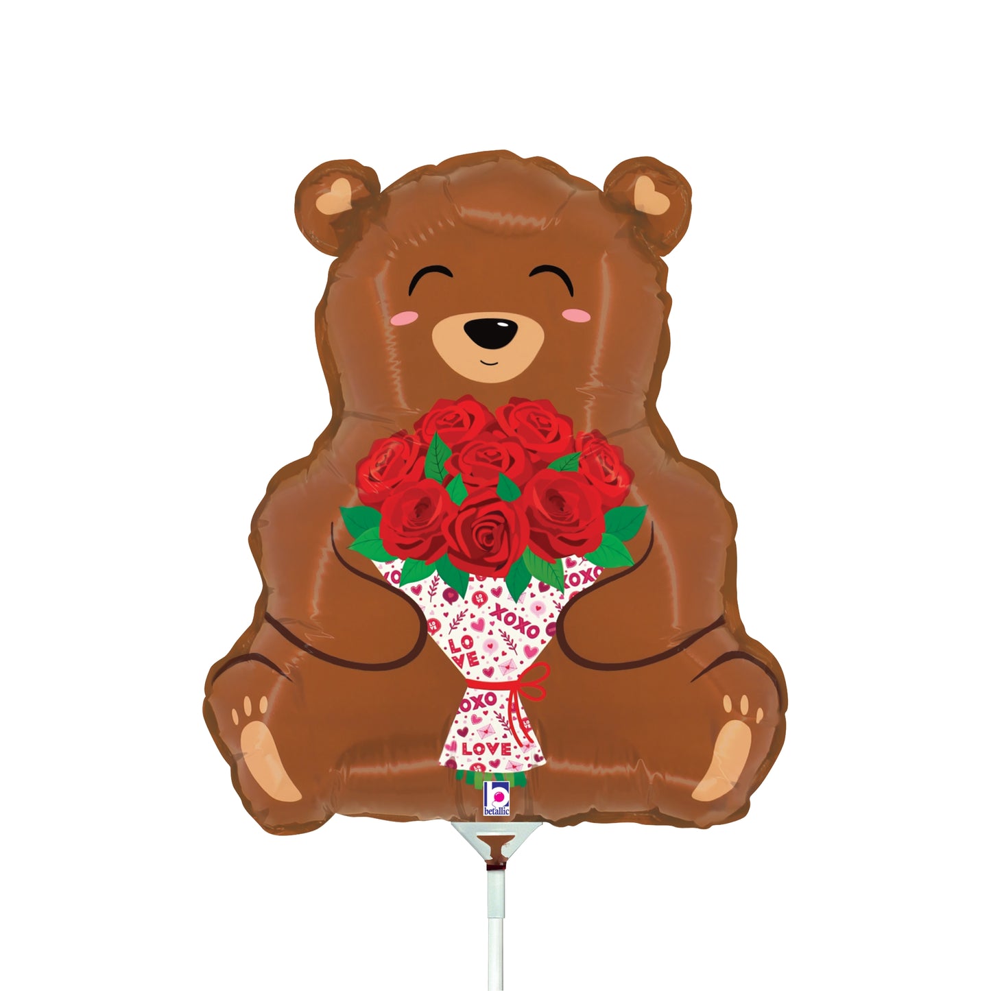 Brown bear-shaped foil balloon holding a bouquet of red roses with green leaves and white wrapping.