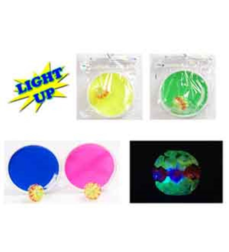 Round plastic spoon rests in blue, pink, yellow, and green with a small fruit-shaped light-up decoration attached.