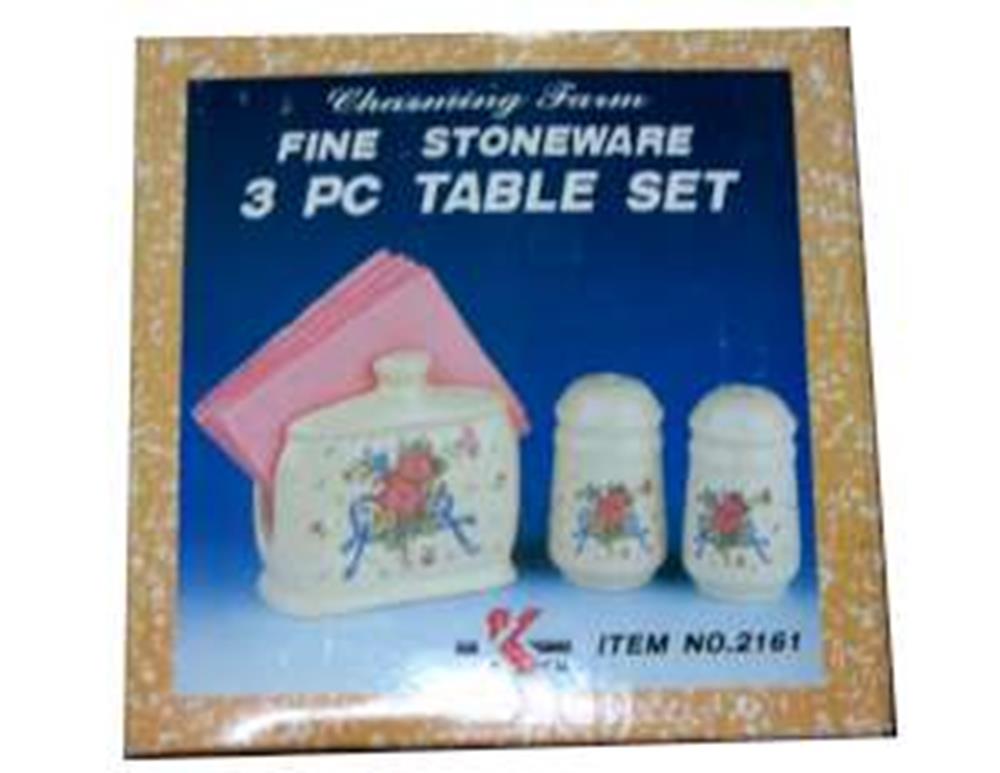 White stoneware 3-piece table set with floral design including salt shaker, pepper shaker, and butter dish with pink napkin.