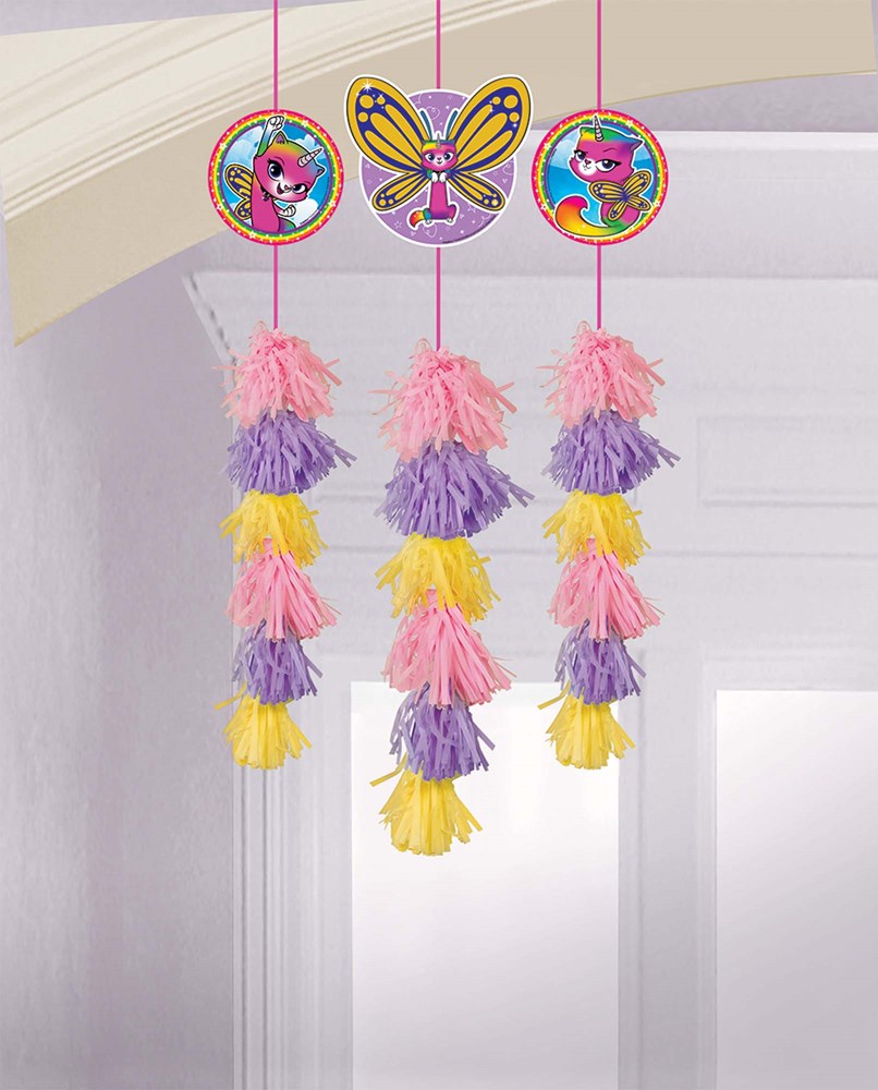 Rainbow butterfly and unicorn kitty round toppers with pink, purple, and yellow tassel dangles hanging from strings.