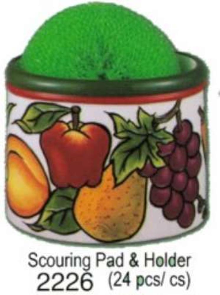 Green mesh fruit scourer pad resting on a round ceramic holder decorated with colorful fruit illustrations including apple,.