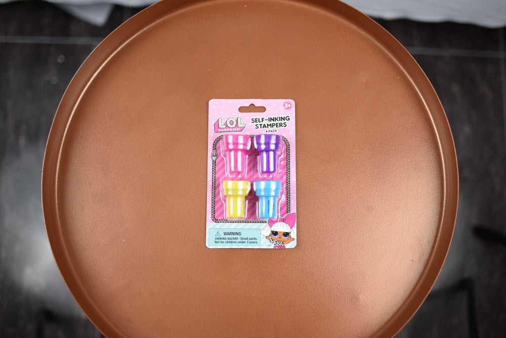 Set of four LOL Surprise self-inking stampers in pink, purple, yellow, and blue with matching caps and character designs on.