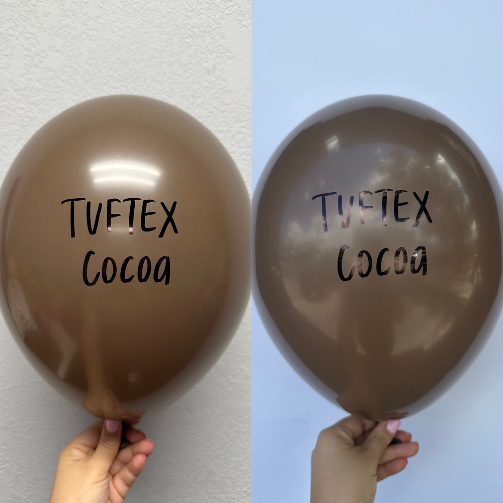 Two large, round, brown latex balloons with "Tuftex Cocoa" printed in black on the front.