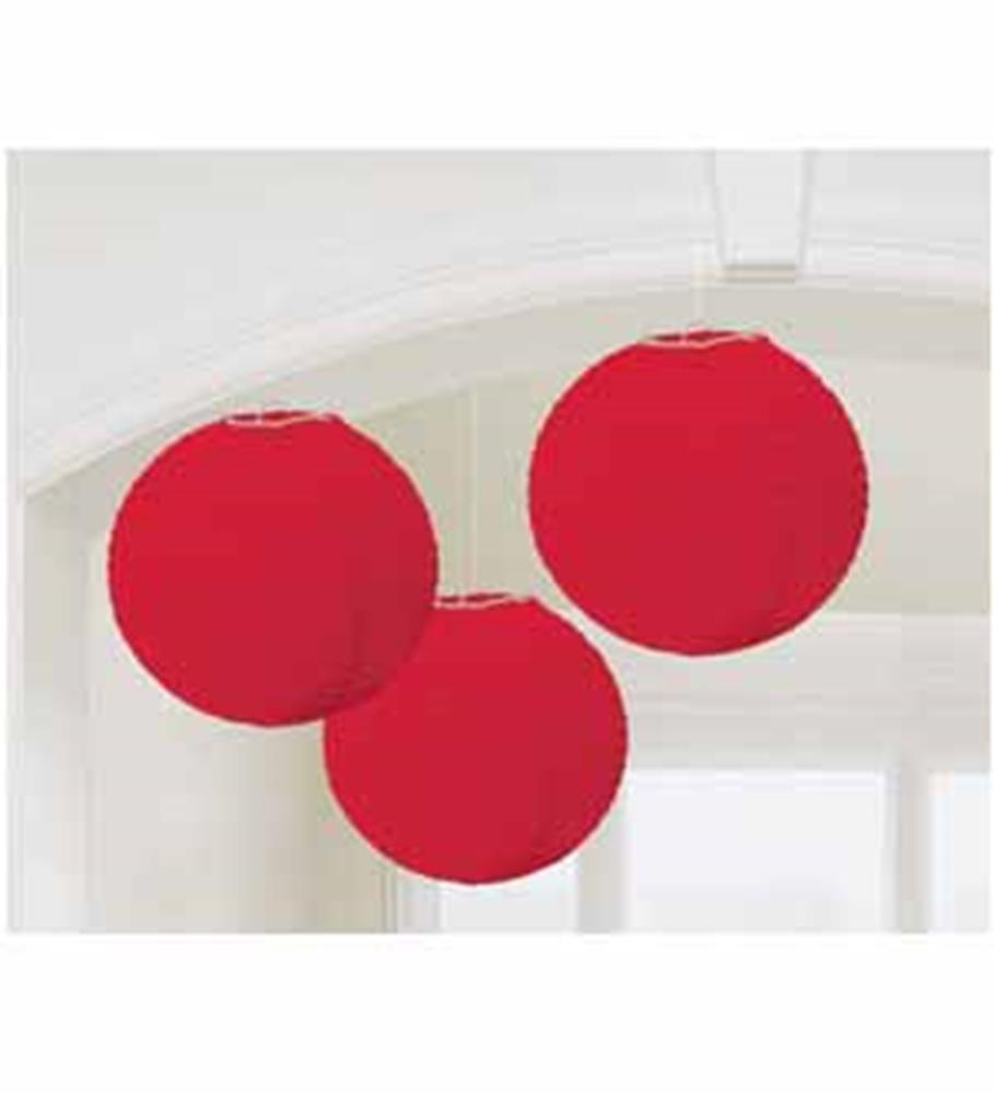 Three bright red round paper lanterns hanging indoors with metal frame supports.