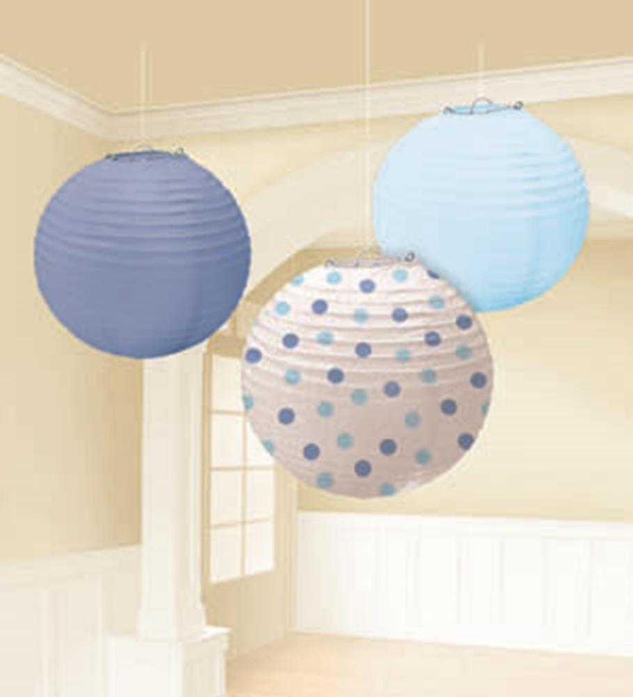 Three round paper lanterns in light blue, lavender, and white with blue polka dots hanging from the ceiling.