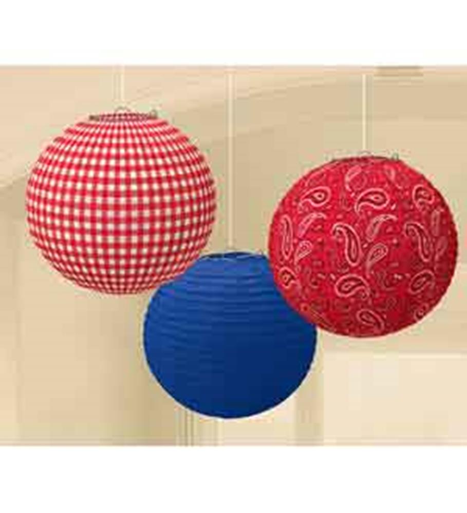 Red and white gingham, solid blue, and red paisley fabric round paper lanterns hanging.