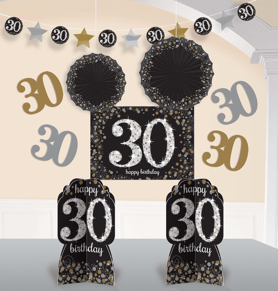 Black and gold 30th birthday party kit with rosettes, glittery centerpiece, hanging garland, and table decorations.